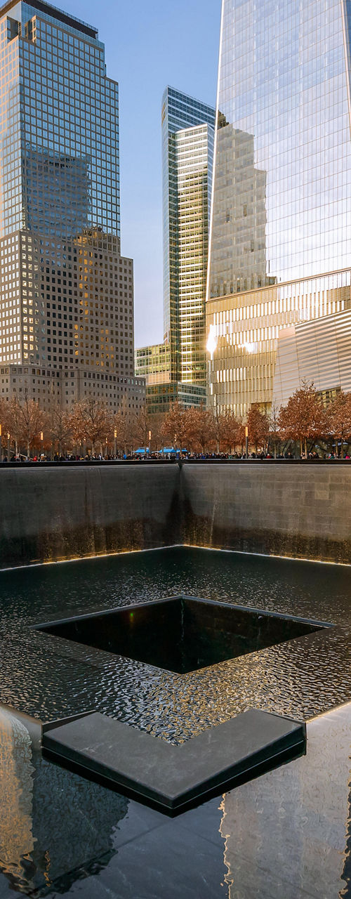 9/11 Memorial with city skyline reflection