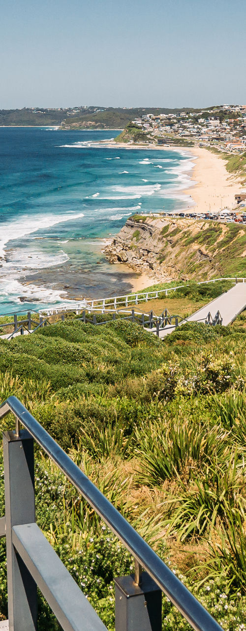 Coastal boardwalk overlooking ocean and seaside town