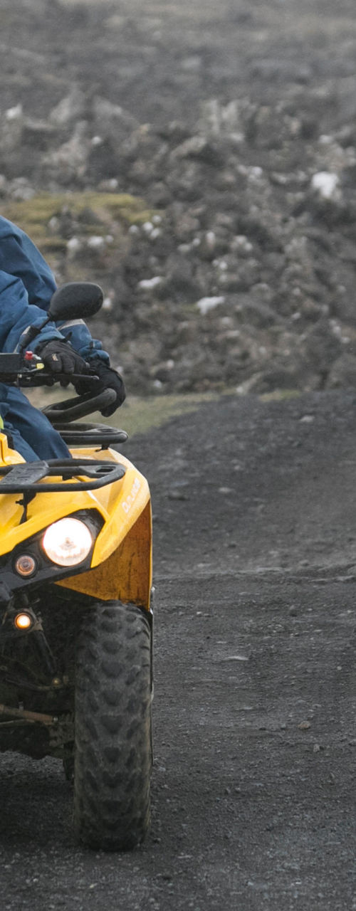 Group riding yellow ATVs on rocky terrain