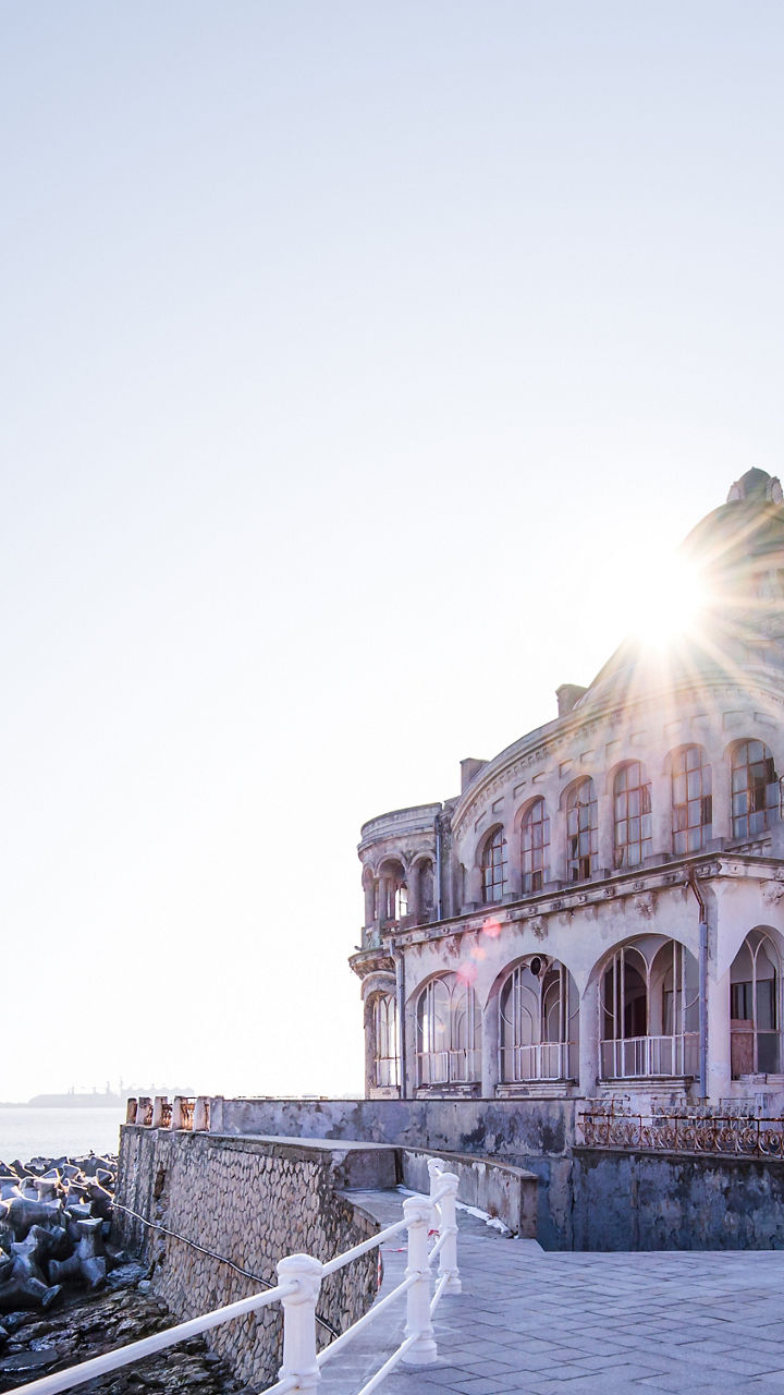 Historic seaside building with sunlit view