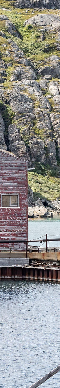 Rustic lakeside building in mountain landscape