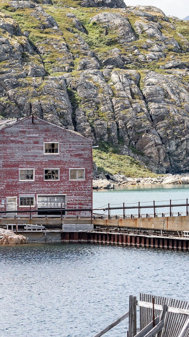 Rustic lakeside building in mountain landscape