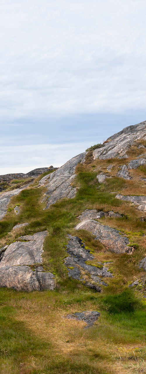 Rustic cabins on rocky hillside landscape