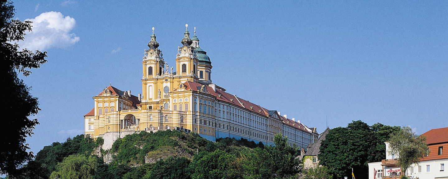 Historic abbey overlooking serene river landscape