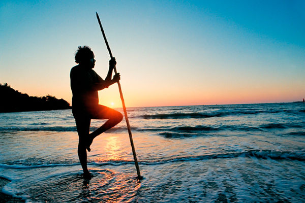 Silhouette of man with spear at sunset