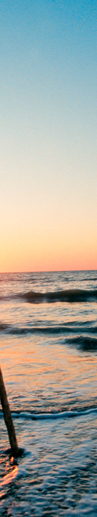 Silhouette of man with spear at sunset