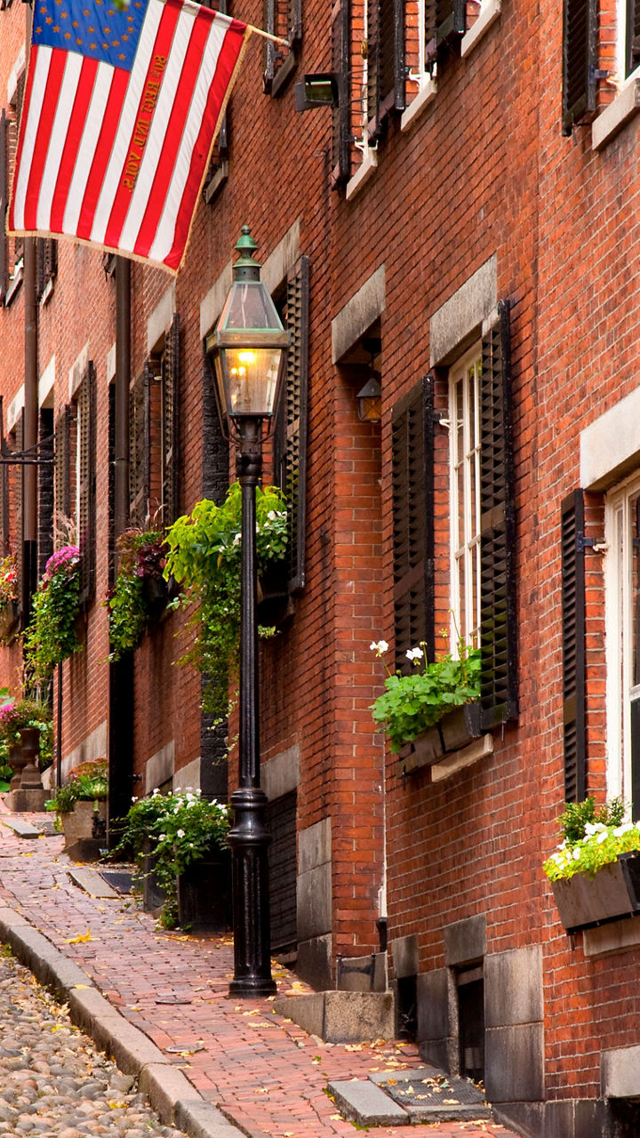 Historic cobblestone street with American flag