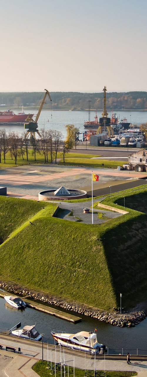 Scenic marina with historic fort and cranes