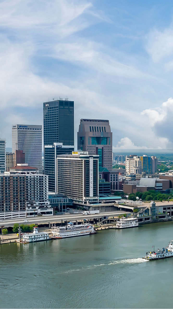 Louisville skyline with river barge