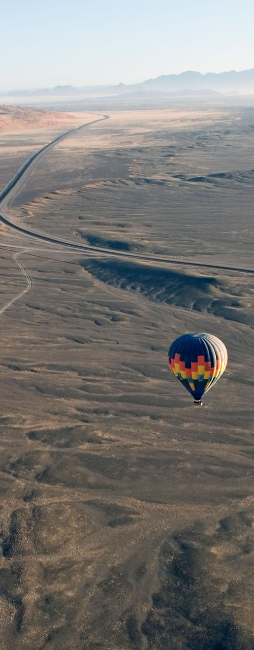 Hot air balloons over desert landscape