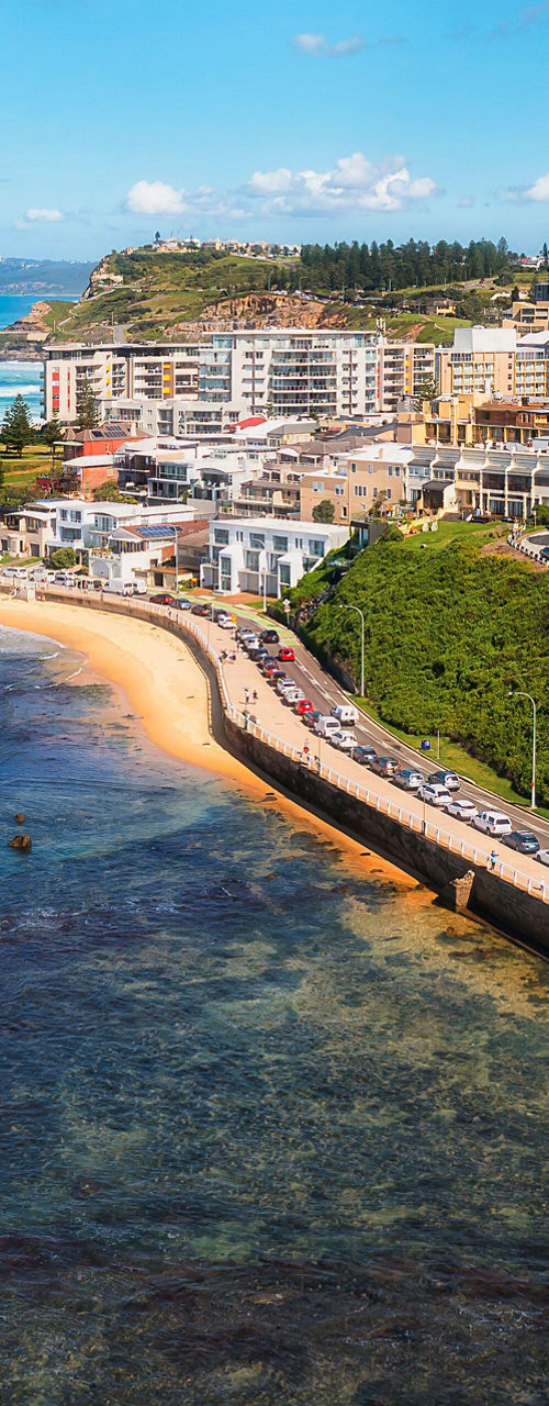 Coastal cityscape with ocean and greenery
