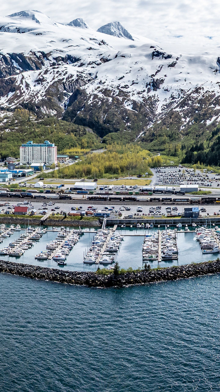 Aerial View of Harbor and Snow-Capped Mountains