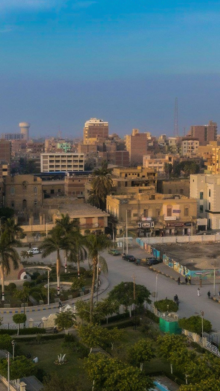 Urban skyline with mosque at sunset