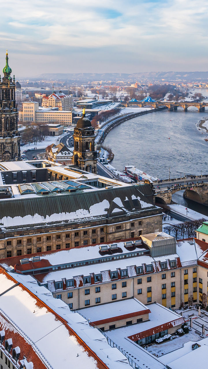 Snowy European cityscape along winding river