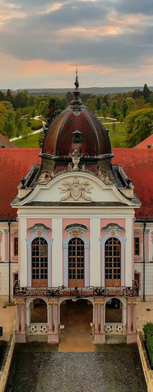 Historic palace with flags at sunset