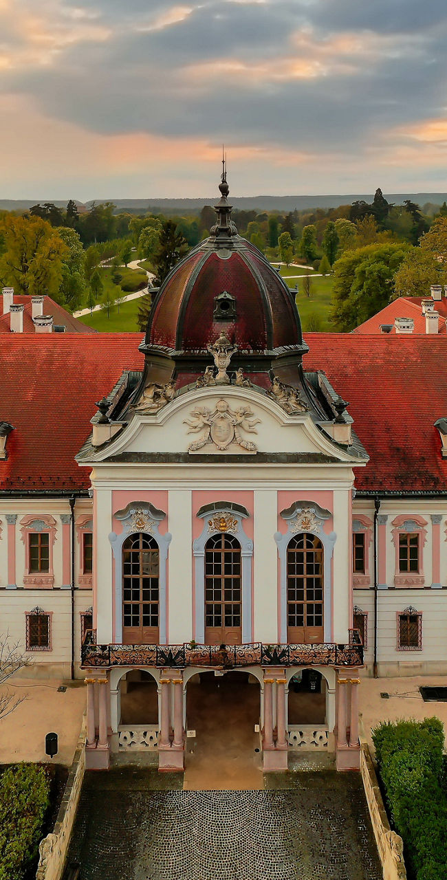 Historic palace with flags at sunset