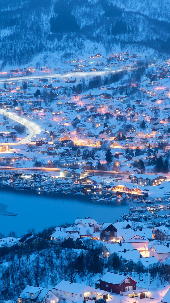 Snowy town illuminated at dusk