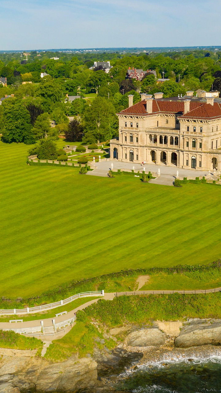 Aerial view of historic mansion by coastline