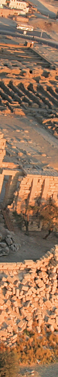 Hot air balloon over ancient ruins at sunrise