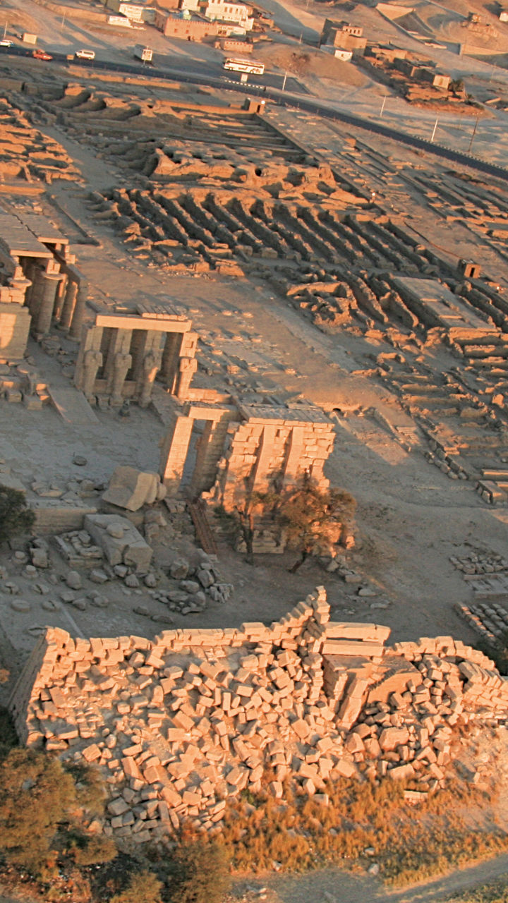 Hot air balloon over ancient ruins at sunrise