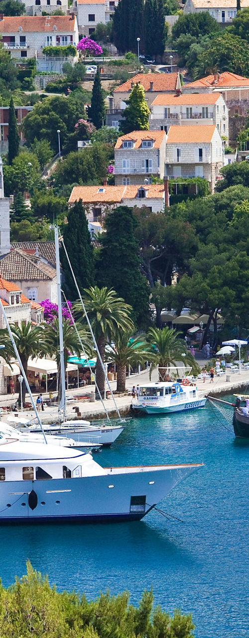 Scenic harbor with yachts and bell tower