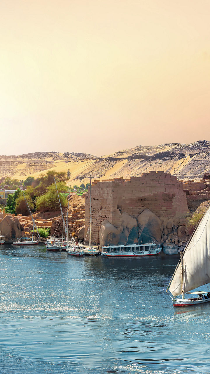 Sailboats cruising a tranquil desert river