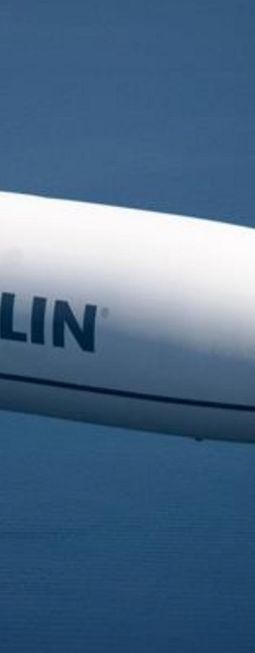 Zeppelin airship flying over calm waters