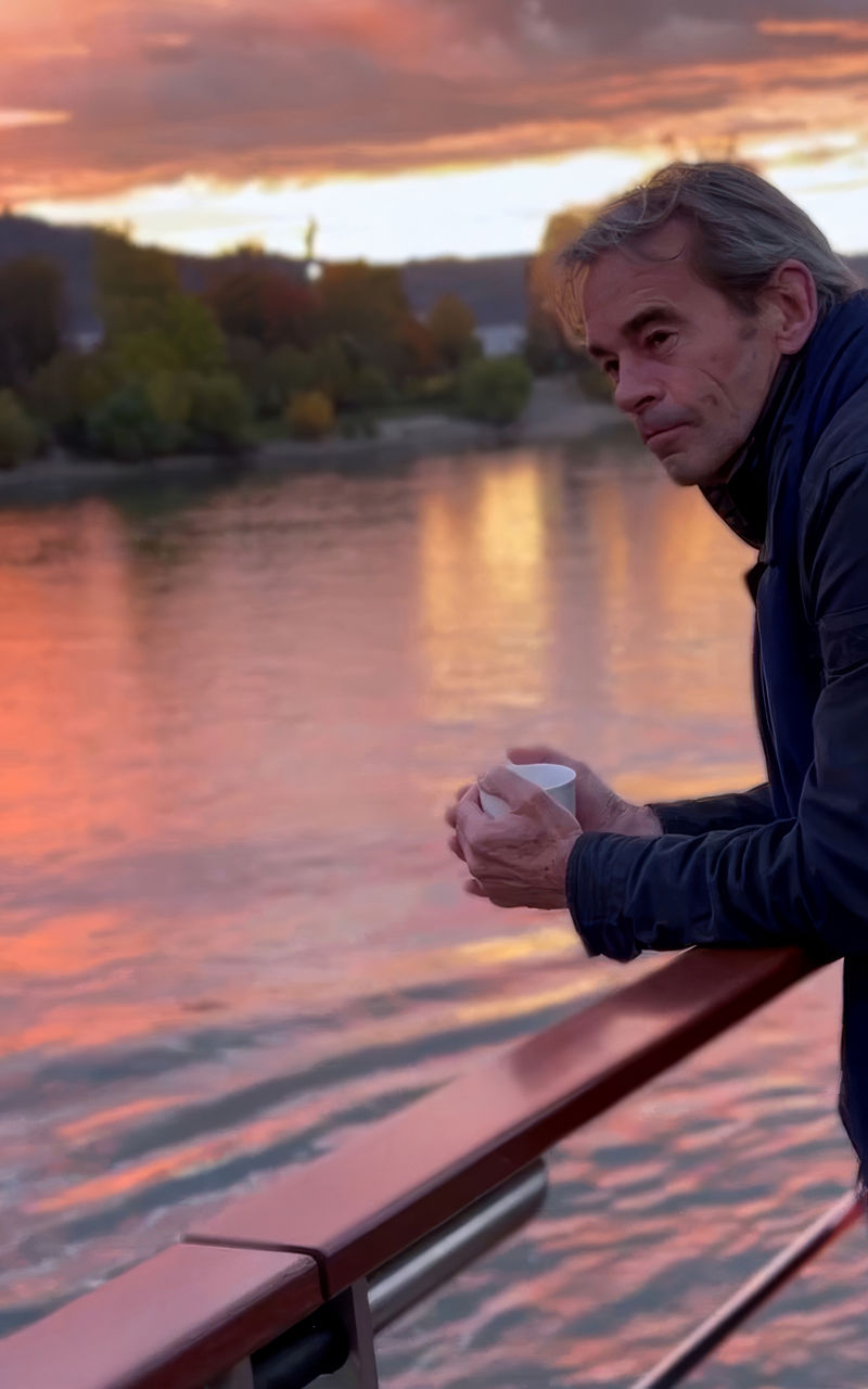Man admiring sunset over river view