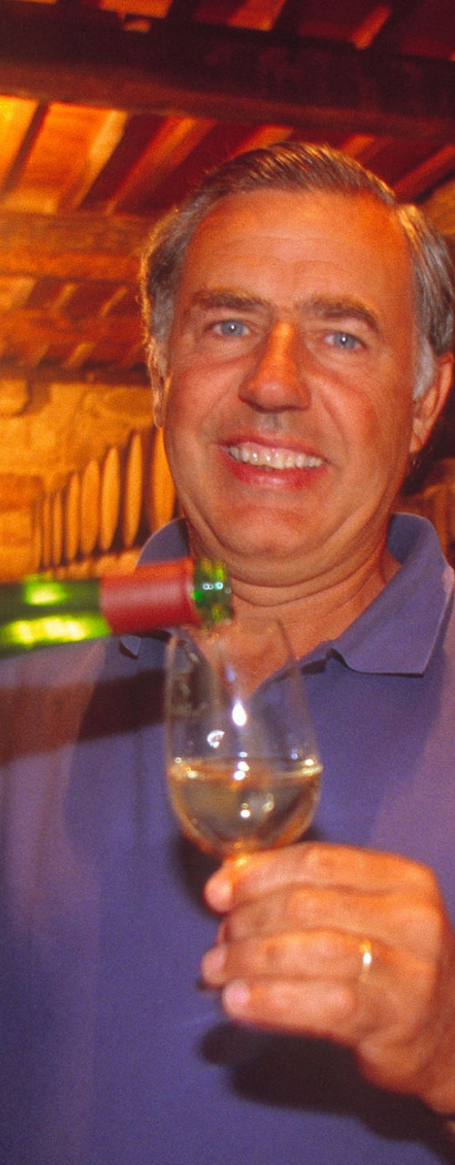 Man pouring wine in rustic cellar