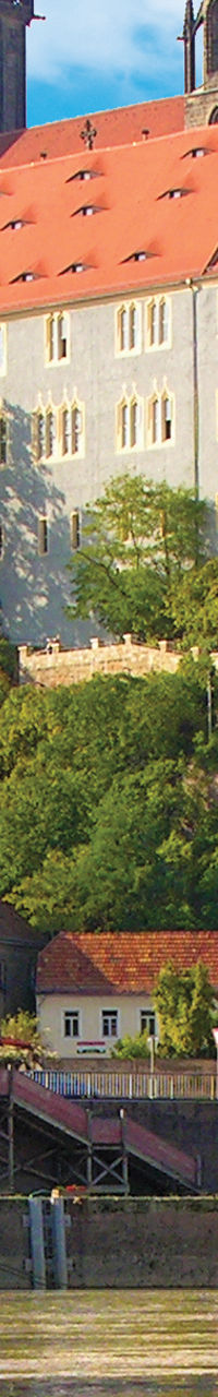 Historic castle by riverside with reflection