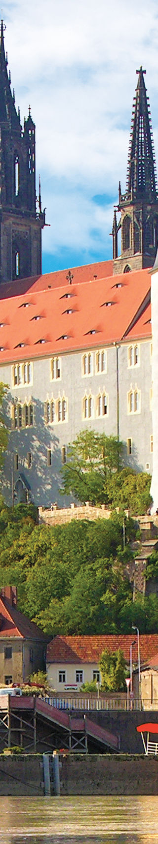 Historic castle by riverside with reflection