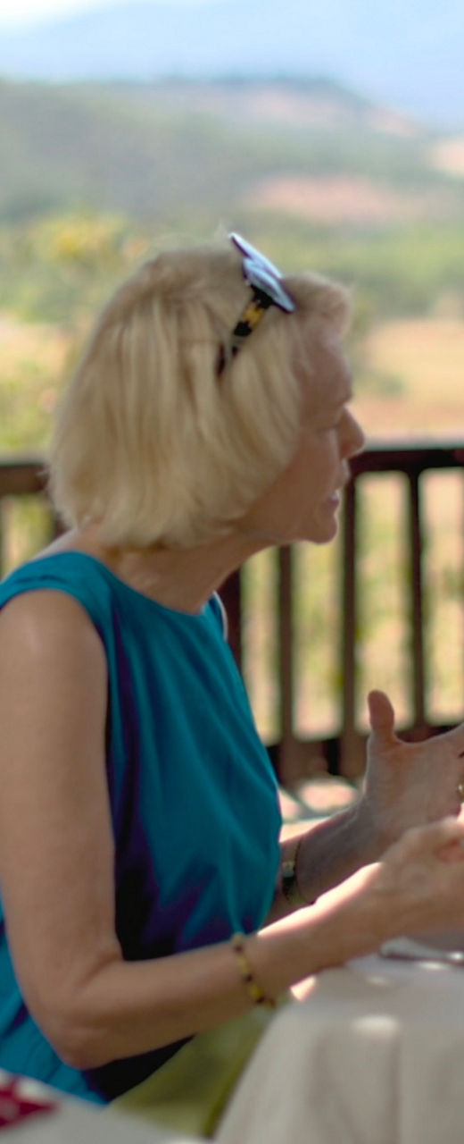 Two adults dining outdoors with scenic view
