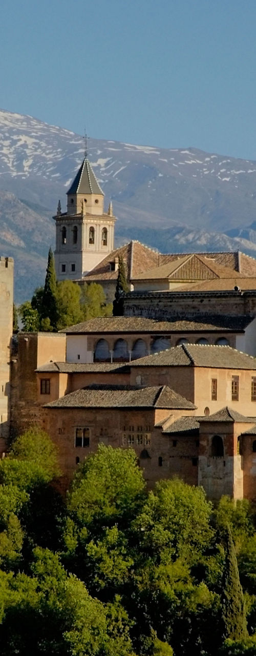 Historic Alhambra Palace with mountain backdrop