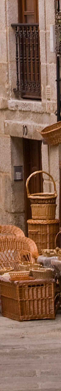 Narrow European street with wicker furniture