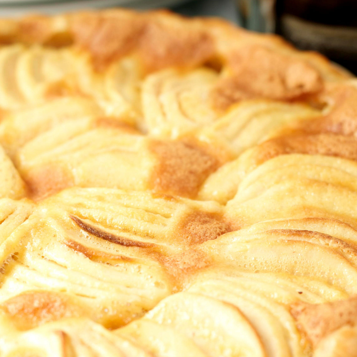 Golden baked apple tart on table