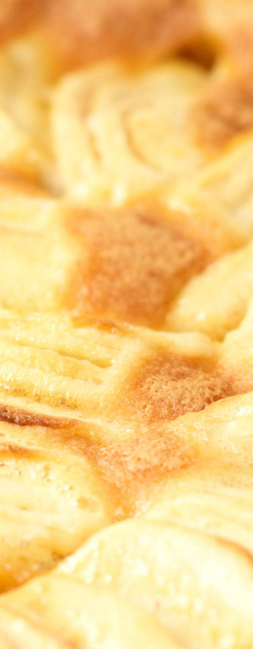 Golden baked apple tart on table