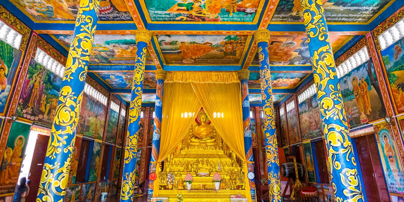 Vibrant Buddhist temple interior with golden shrine