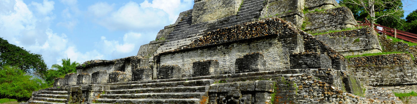 Ancient Mayan pyramid in lush landscape