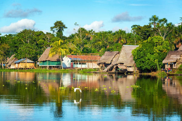 Riverside village with traditional huts