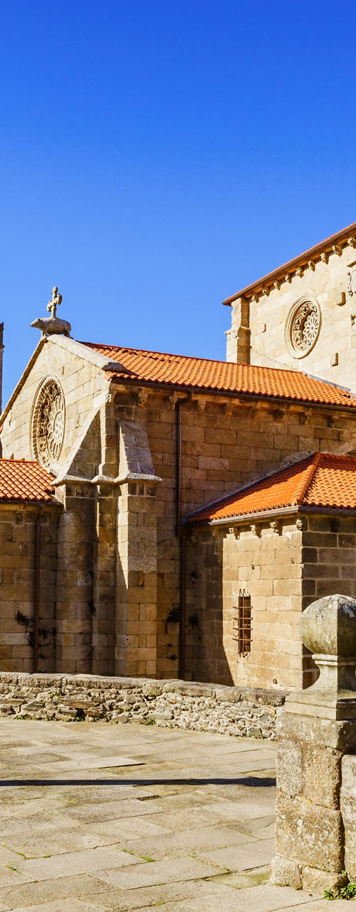 Historic stone church in sunny plaza