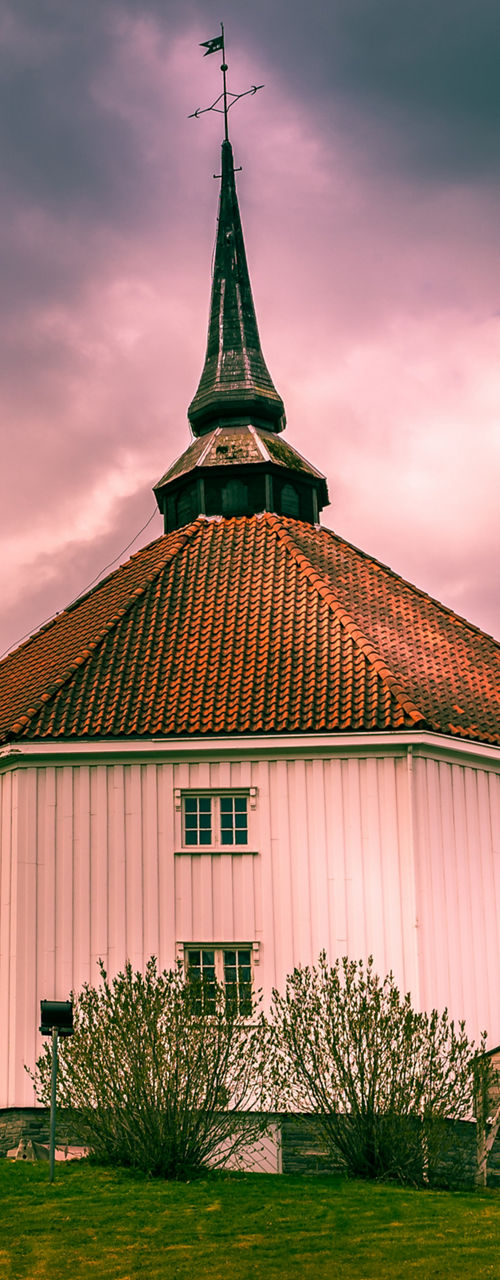 Historic round church under dramatic skies
