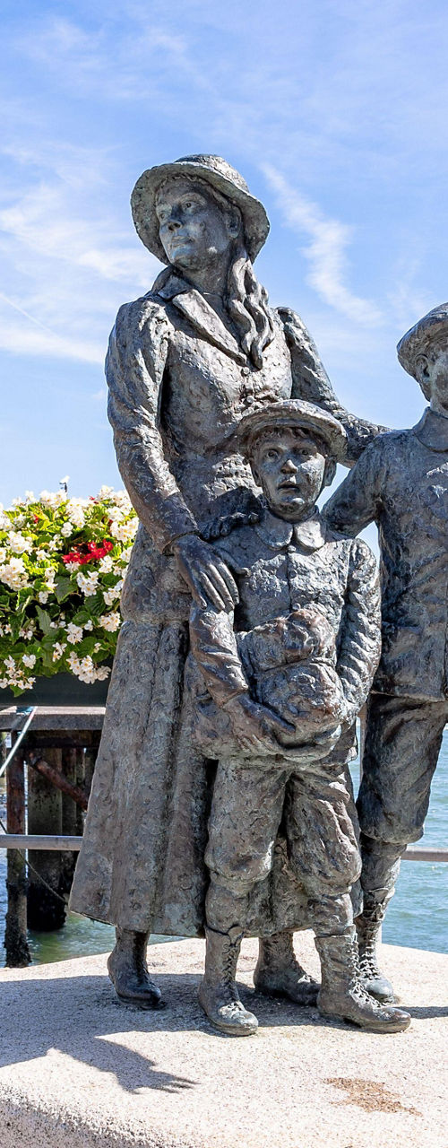Seaside family statue with floral decor