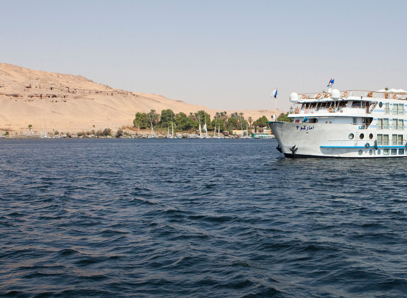 Cruise ship on Nile River near desert