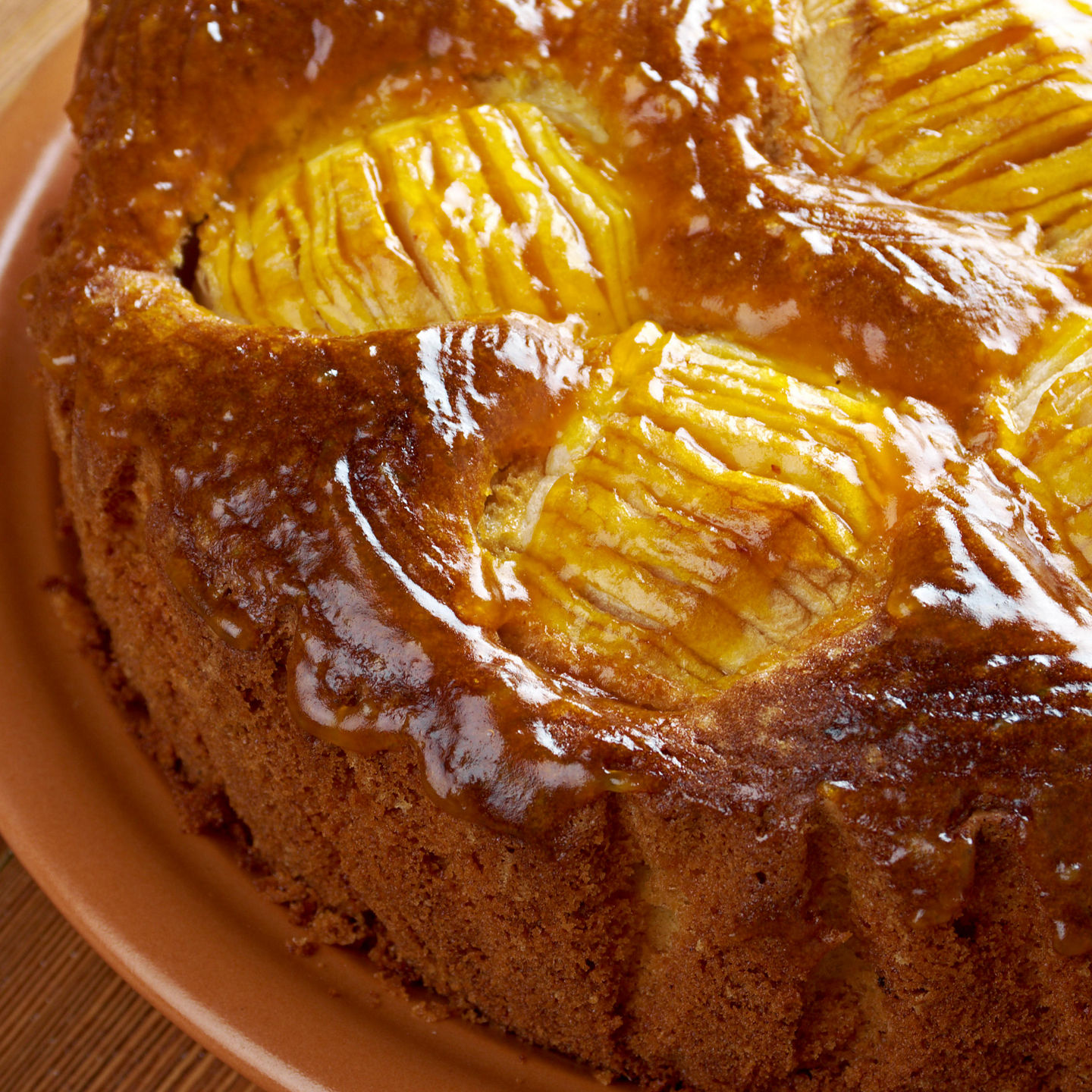Golden apple cake on ceramic plate
