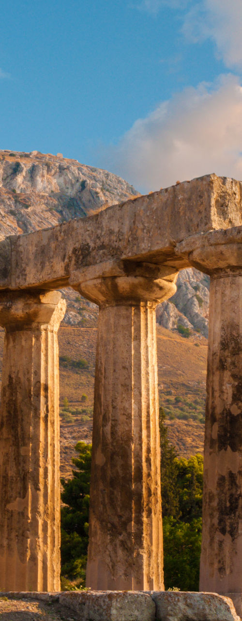 Ancient Greek ruins with mountain backdrop