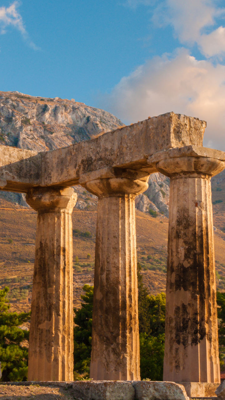 Ancient Greek ruins with mountain backdrop