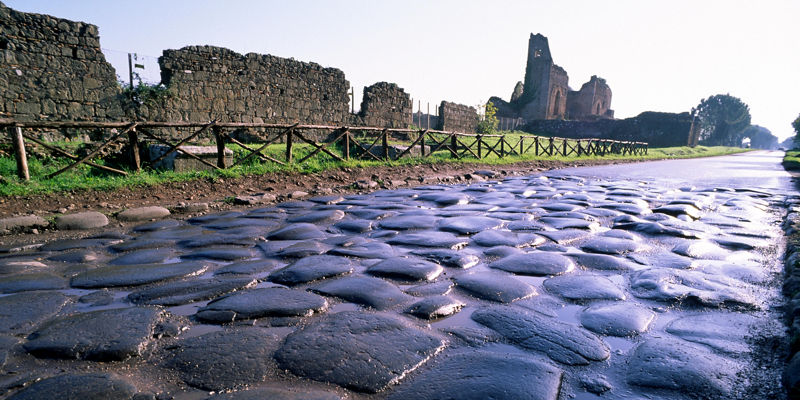 Ancient cobblestone road with ruins