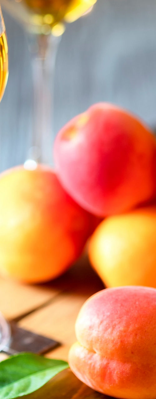 Apricots with glasses of golden liquor