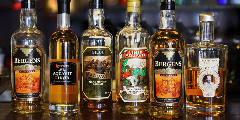Assorted aquavit bottles on a bar counter