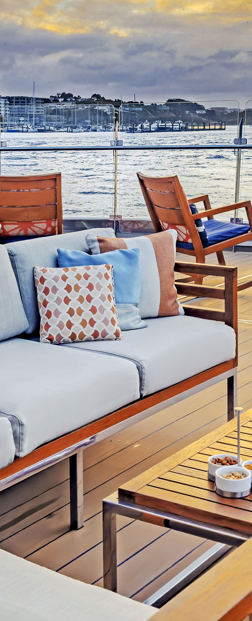 Luxury waterfront terrace at colorful sunset
